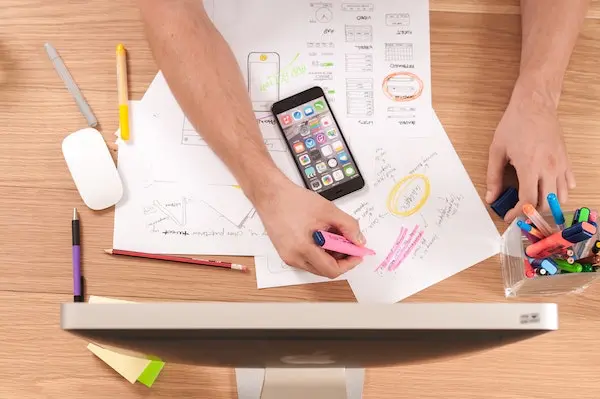 admin highlighting information on paper at desk with phone