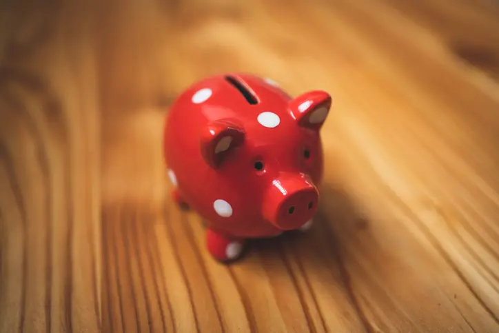 piggy-bank red and white polka dot piggy bank on wooden surface
