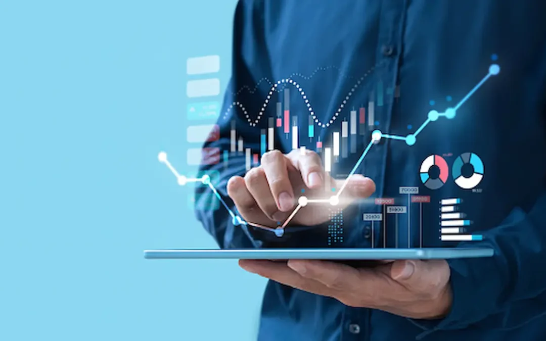man typing on digital tablet with holographic trends and statistics images hovering above