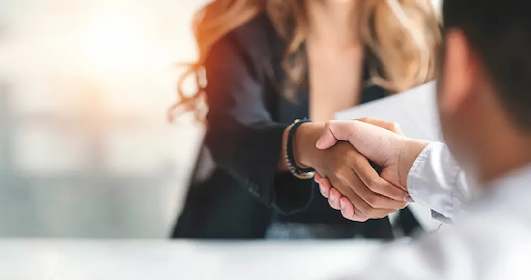 Two office workers shaking hands